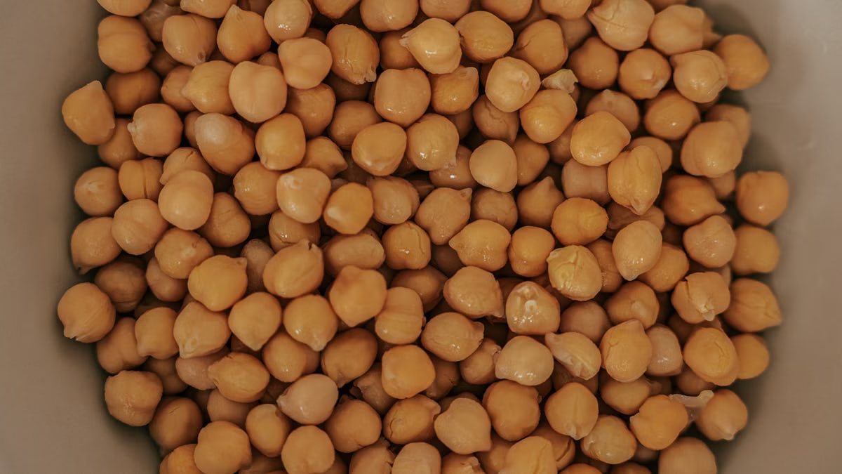 A detailed overhead shot of fresh chickpeas in a bowl, perfect for culinary uses.